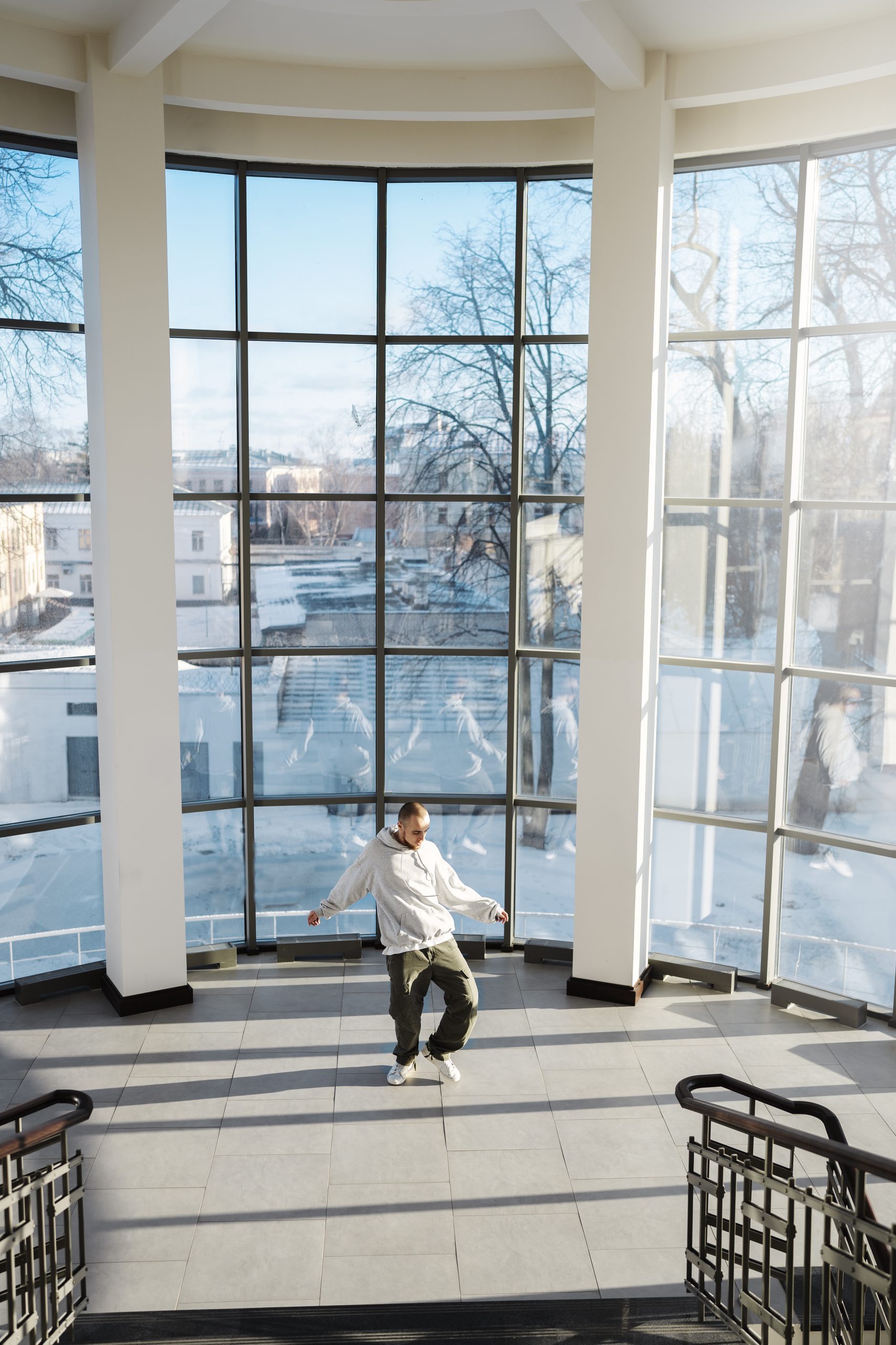 young-male-performer-dancing-building-with-big-windows